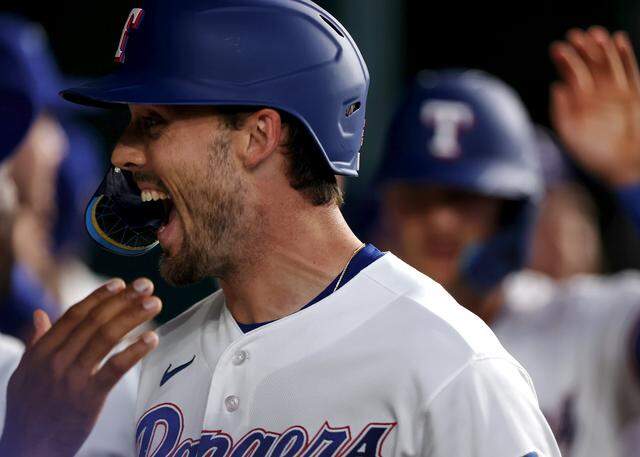 Texas Rangers outfielder Evan Carter celebrates in the dugout after scoring a run against the Cincinnati Reds on Friday, April 3, 2026.